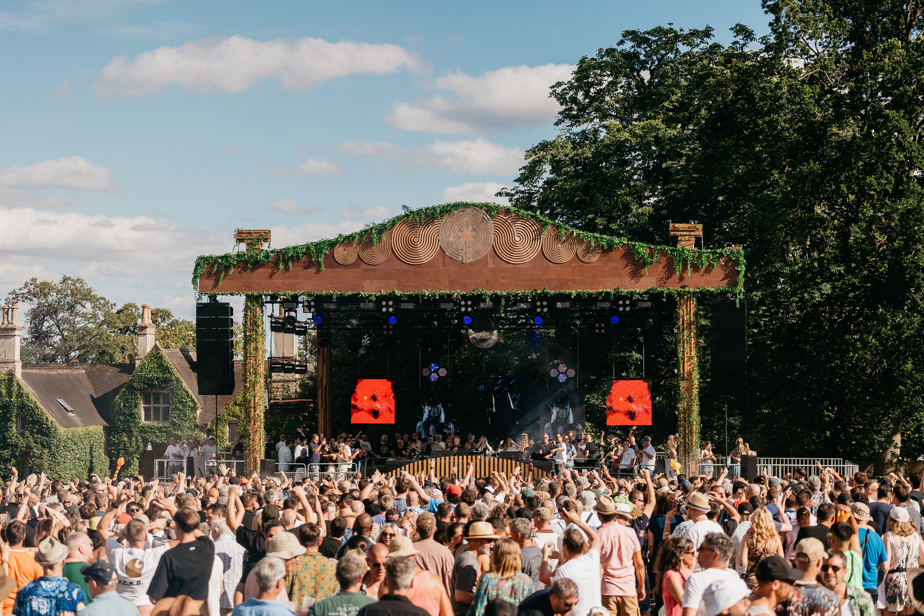 Main tent crowd with sun beams and festival atmosphere